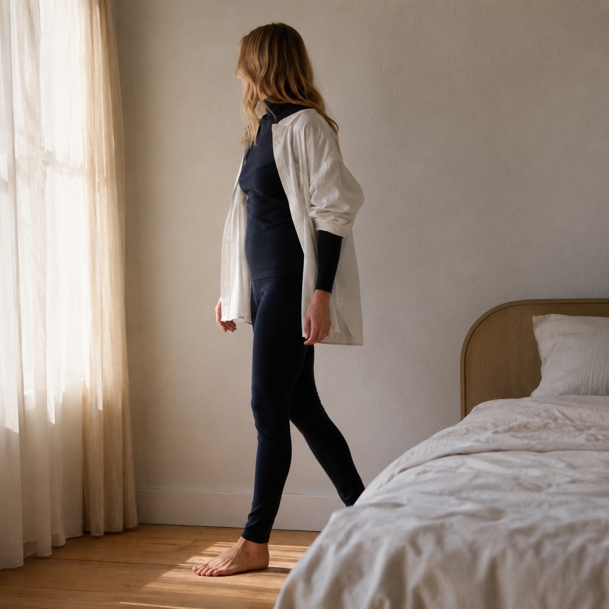 Rowledge high-neck long-sleeve base layer — Long-Sleeve Base Layers by FITS LIKE. worn by a model, side view.